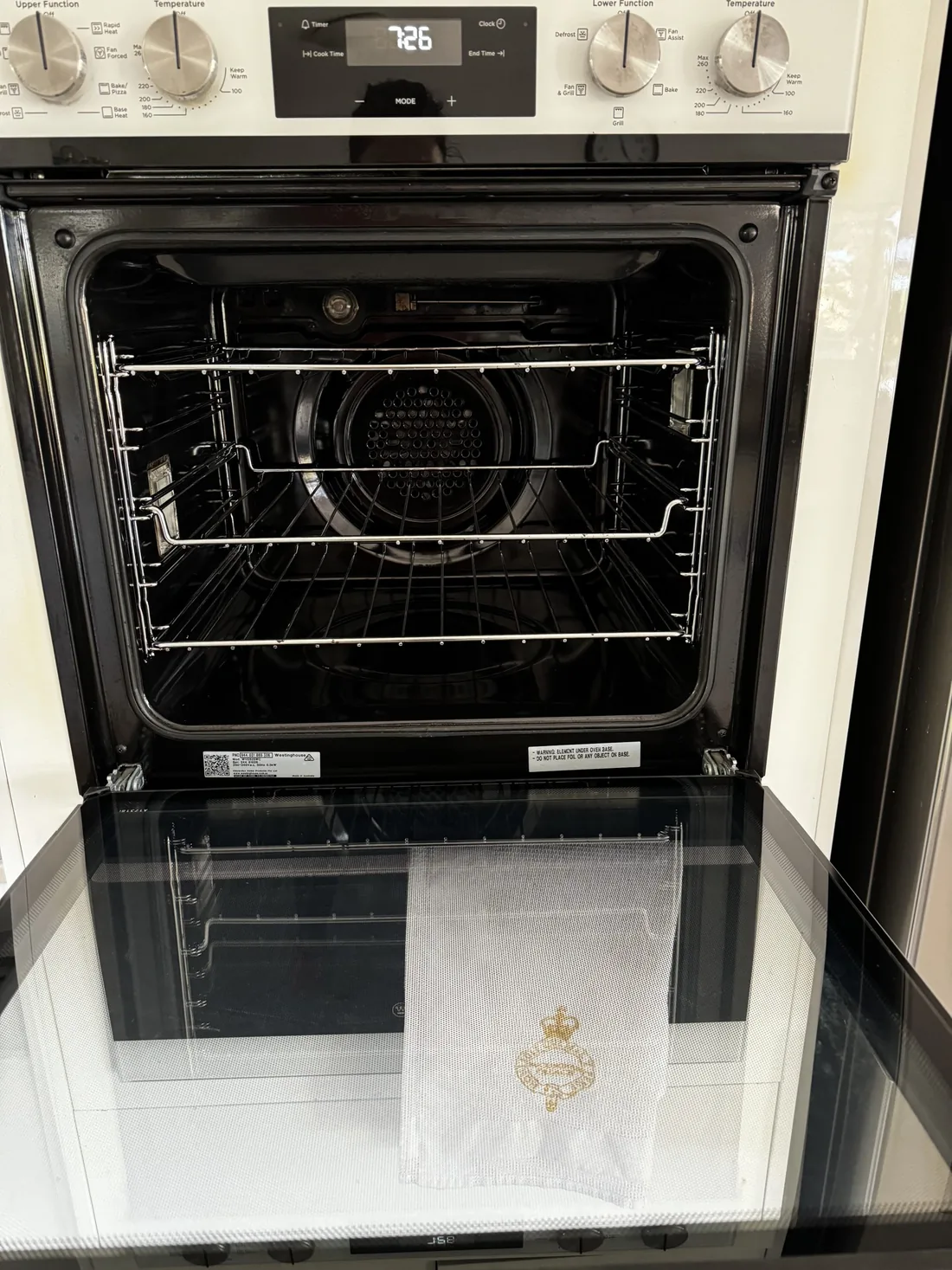 The same oven after cleaning. The racks are bright, the back plate is clear and the door glass is transparent.